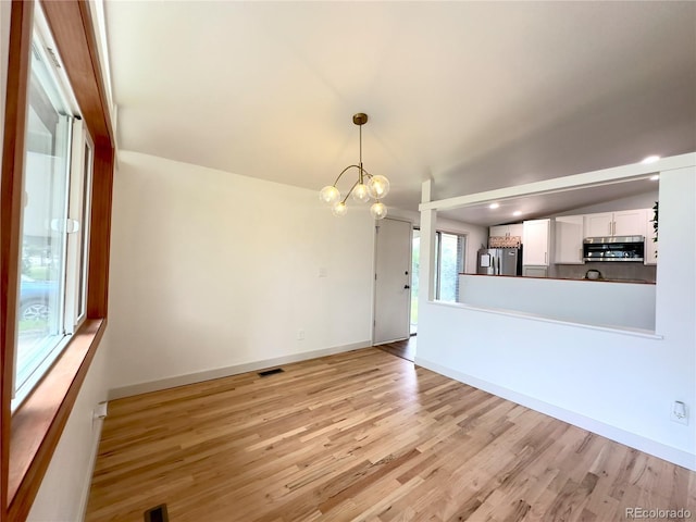 3355 Moorhead Ave, Boulder, CO 80305 - unfurnished living room featuring a chandelier, light wood-type flooring, and baseboards