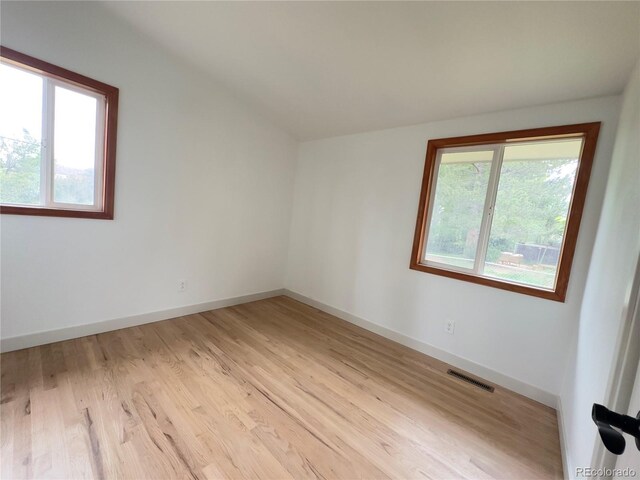 3355 Moorhead Ave, Boulder, CO 80305 - empty room featuring healthy amount of natural light, light wood-type flooring, baseboards, and lofted ceiling
