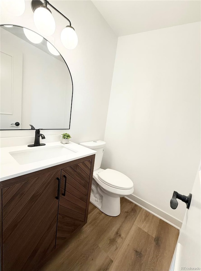 3355 Moorhead Ave, Boulder, CO 80305 - bathroom featuring wood finished floors, baseboards, vanity, and toilet