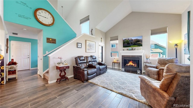 10449 Paris St Unit 207, Commerce City, CO 80640 - living area featuring high vaulted ceiling, wood finished floors, and a fireplace with flush hearth