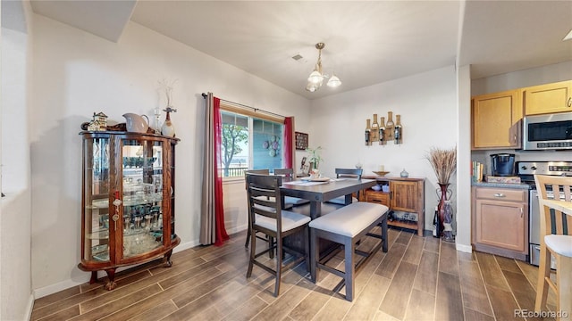 10449 Paris St Unit 207, Commerce City, CO 80640 - dining space with wood finished floors and a chandelier