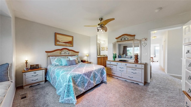 10449 Paris St Unit 207, Commerce City, CO 80640 - bedroom featuring light colored carpet, a ceiling fan, and ensuite bath