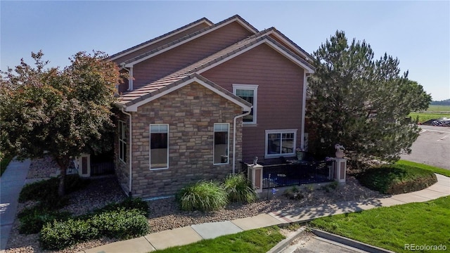 10449 Paris St Unit 207, Commerce City, CO 80640 - view of front of house with stone siding