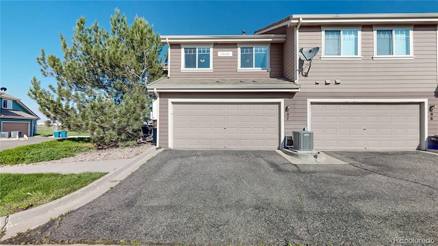 10449 Paris St Unit 207, Commerce City, CO 80640 - view of front of house with a garage and asphalt driveway