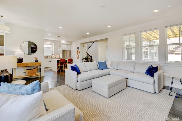 living area with recessed lighting, plenty of natural light, and dark wood-style flooring