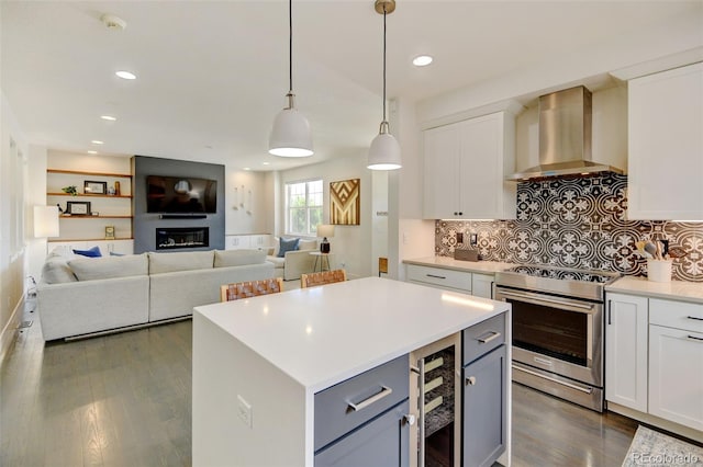 kitchen with dark wood-style flooring, electric range, light countertops, beverage cooler, and wall chimney exhaust hood