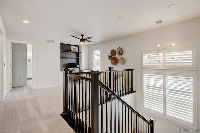 corridor featuring light colored carpet, recessed lighting, baseboards, an upstairs landing, and visible vents