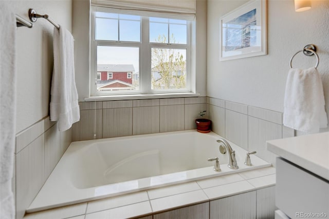full bath featuring a bath and vanity