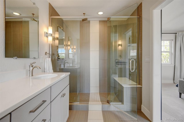 bathroom featuring recessed lighting, a stall shower, and vanity