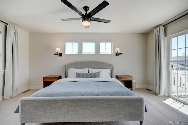 bedroom with access to outside, baseboards, multiple windows, and light carpet