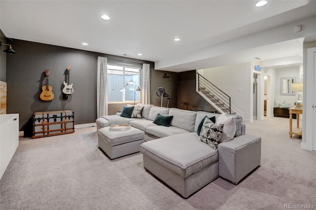 living room featuring stairs, recessed lighting, baseboards, and light colored carpet