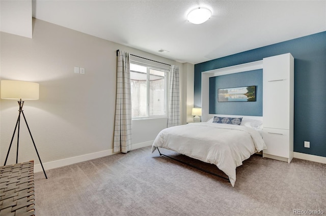 bedroom featuring baseboards and carpet