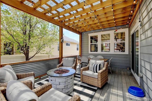 deck featuring fence, an outdoor living space with a fire pit, a pergola, and outdoor dining area