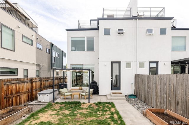 rear view of house with a pergola, an outdoor hangout area, and a patio area