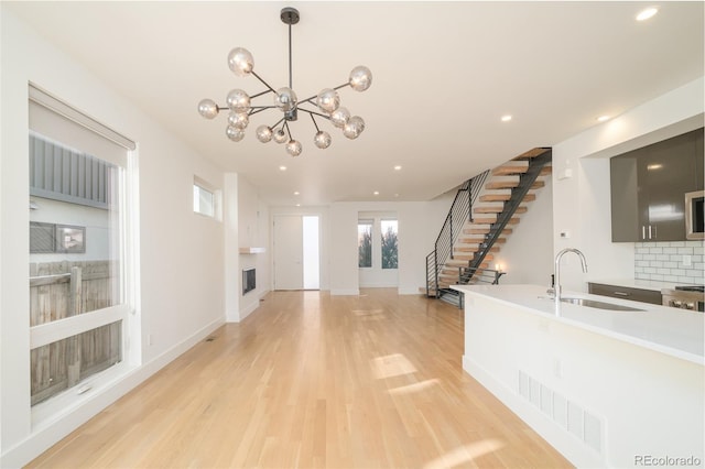 foyer featuring a fireplace, light hardwood / wood-style floors, and sink