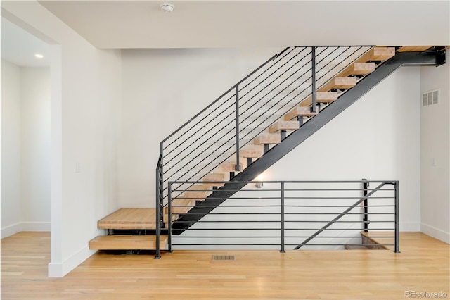 staircase featuring wood-type flooring