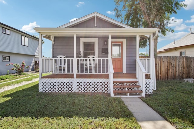 130 N 8th Ave, Brighton, CO 80601 - view of front of house with covered porch and board and batten siding