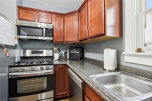 130 N 8th Ave, Brighton, CO 80601 - kitchen featuring appliances with stainless steel finishes and dark countertops