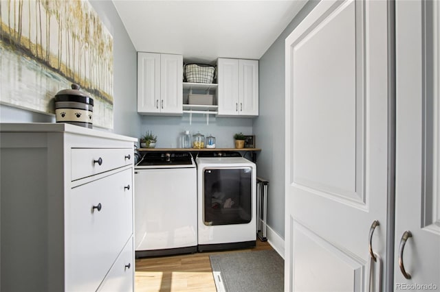 130 N 8th Ave, Brighton, CO 80601 - laundry room featuring washer and clothes dryer, light wood-style flooring, and cabinet space