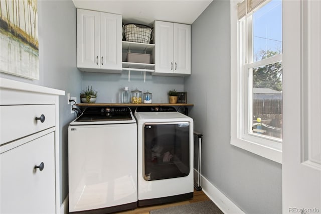 130 N 8th Ave, Brighton, CO 80601 - washroom with washing machine and clothes dryer, cabinet space, and wood finished floors