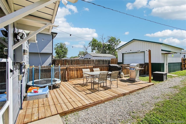 130 N 8th Ave, Brighton, CO 80601 - wooden deck with a fenced backyard, outdoor dining area, a garage, an outdoor structure, and area for grilling