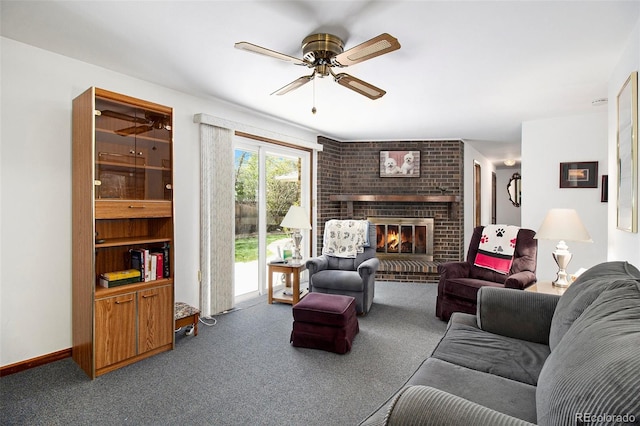 living area featuring carpet flooring, a fireplace, baseboards, and ceiling fan