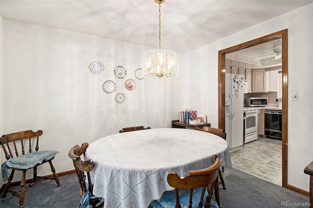 dining room featuring baseboards, a chandelier, and light colored carpet