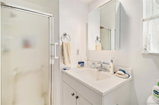 full bath with a stall shower and vanity