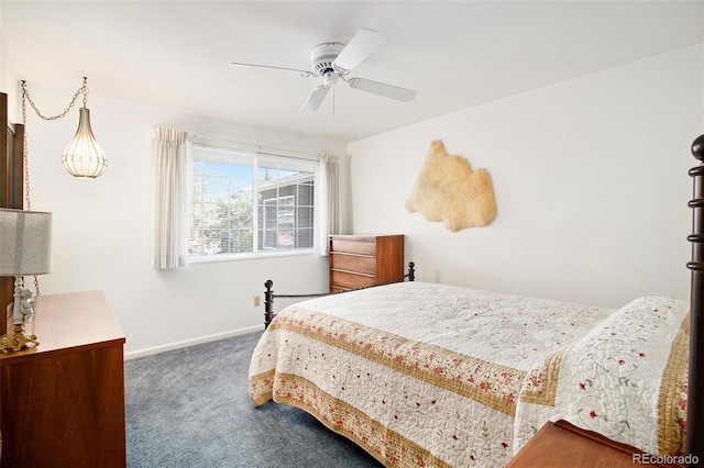 carpeted bedroom featuring baseboards and a ceiling fan