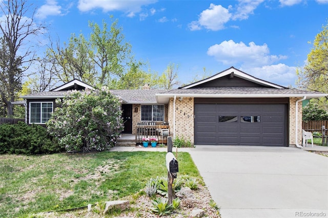 ranch-style house featuring fence, brick siding, driveway, a garage, and a front yard