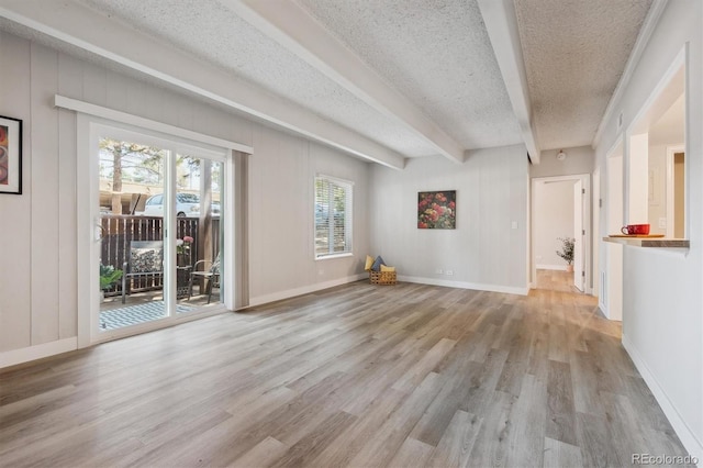 9700 E Iliff Ave Unit A3, Denver, CO 80231 - unfurnished living room featuring a textured ceiling, wood finished floors, and beam ceiling