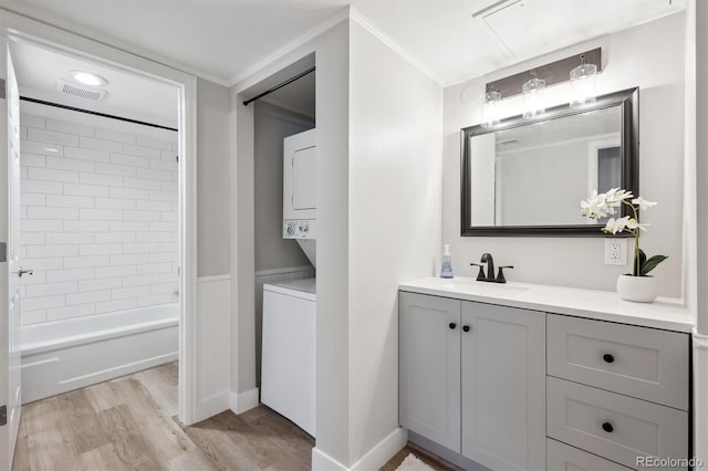 9700 E Iliff Ave Unit A3, Denver, CO 80231 - full bathroom with stacked washer / dryer, vanity, crown molding, wood finished floors, and  shower combination