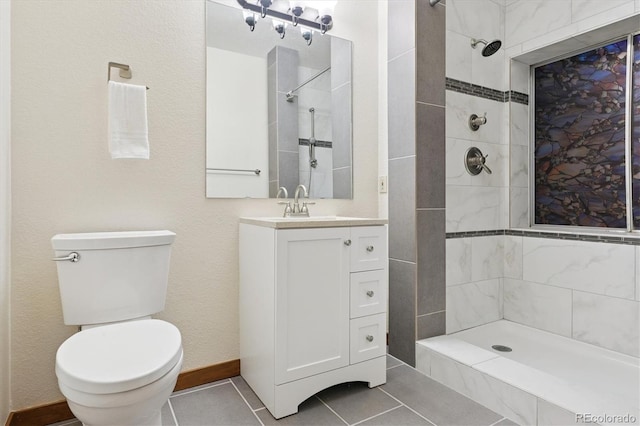 full bath featuring tile patterned flooring, a tile shower, toilet, and vanity