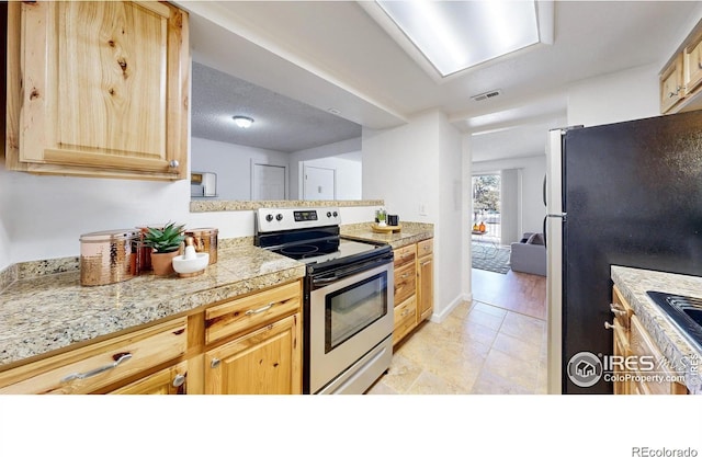 kitchen with appliances with stainless steel finishes, visible vents, tile countertops, and light brown cabinetry