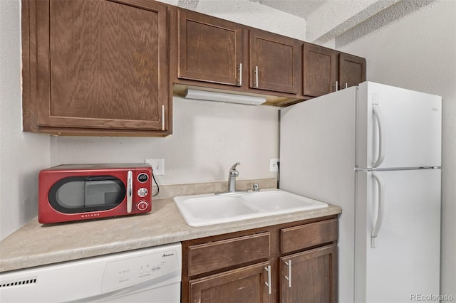 kitchen with white appliances and sink