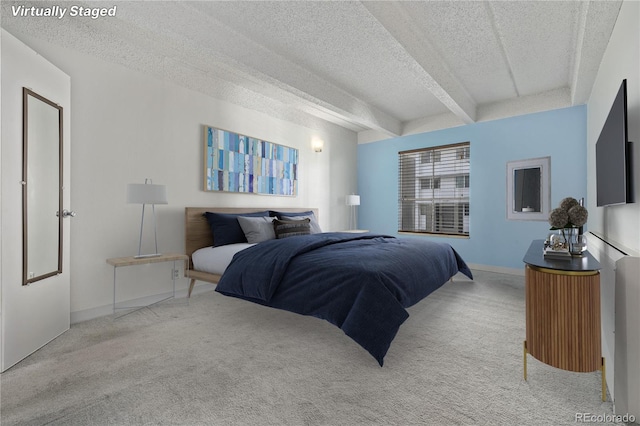 carpeted bedroom with beam ceiling and a textured ceiling