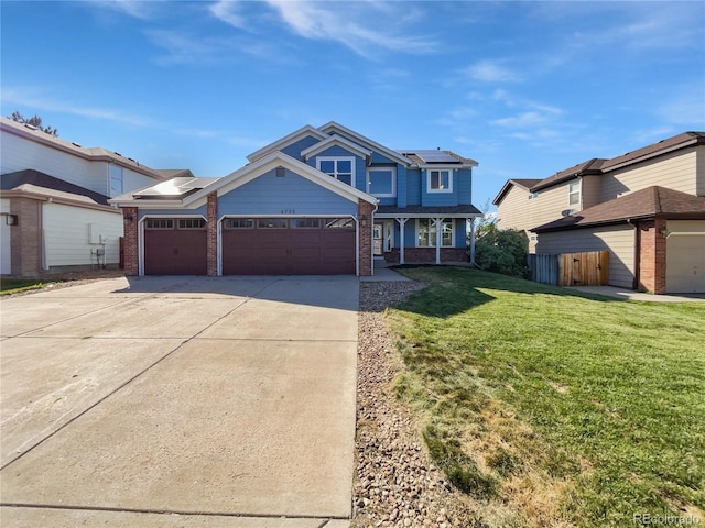 4735 S Cathay Ct, Aurora, CO 80015 - view of front facade with brick siding, roof mounted solar panels, a porch, driveway, and an attached garage