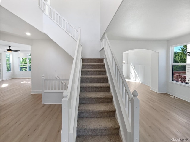 4735 S Cathay Ct, Aurora, CO 80015 - stairway with wood finished floors, plenty of natural light, arched walkways, a ceiling fan, and recessed lighting