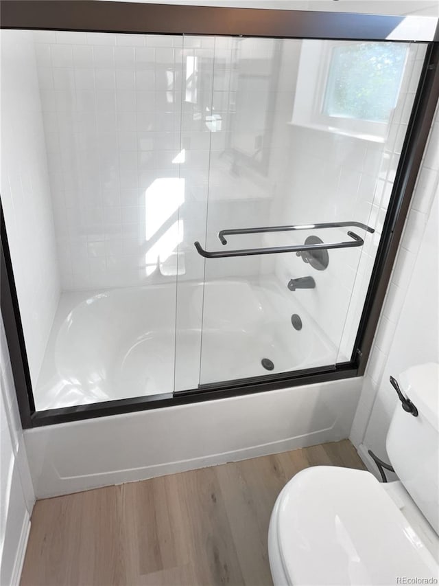 4735 S Cathay Ct, Aurora, CO 80015 - bathroom featuring combined bath / shower with glass door and wood finished floors