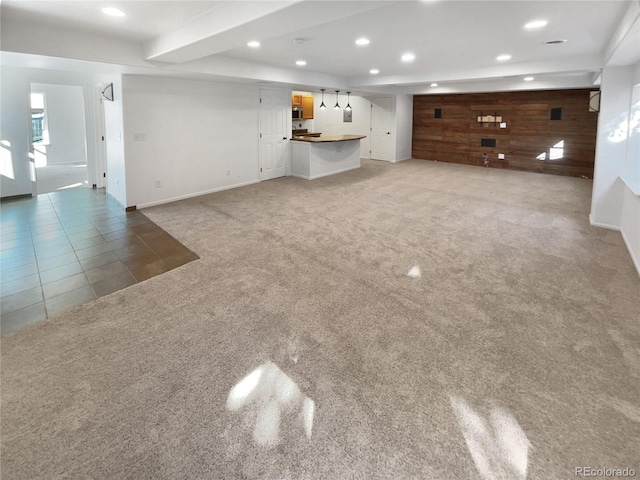 4735 S Cathay Ct, Aurora, CO 80015 - unfurnished living room with light carpet, wood walls, recessed lighting, and light tile patterned flooring