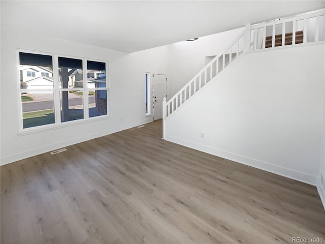 4735 S Cathay Ct, Aurora, CO 80015 - unfurnished living room with stairs and wood finished floors