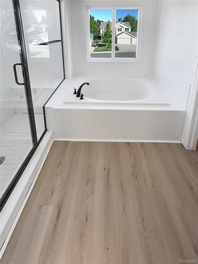 4735 S Cathay Ct, Aurora, CO 80015 - full bath featuring wood finished floors, a garden tub, and a shower stall