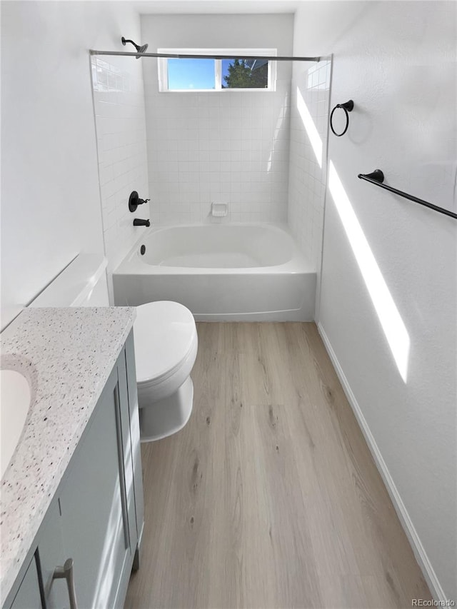 4735 S Cathay Ct, Aurora, CO 80015 - bathroom featuring wood finished floors, vanity, and shower / bathtub combination