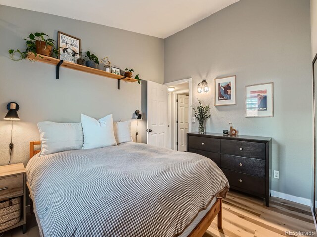 bedroom with baseboards and light wood-type flooring