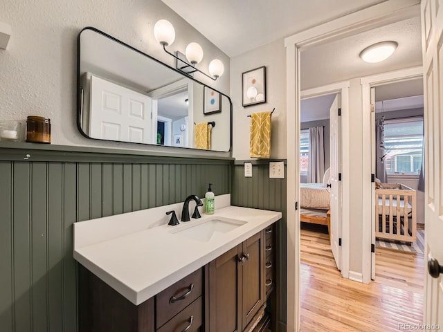 bathroom with vanity and wood finished floors