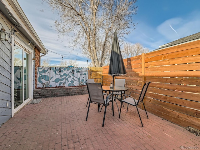 view of patio with outdoor dining area and a fenced backyard