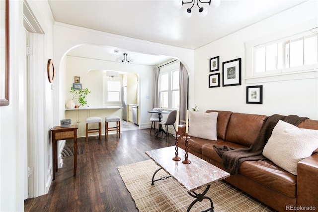 living room featuring dark hardwood / wood-style flooring and an inviting chandelier