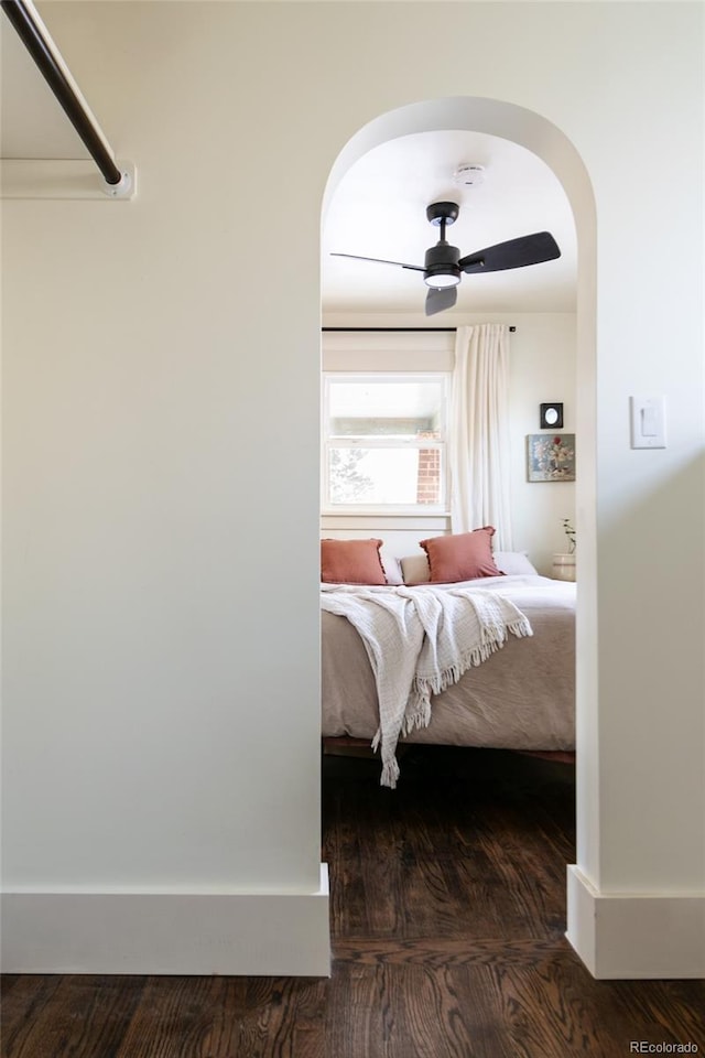 bedroom with ceiling fan and dark hardwood / wood-style floors