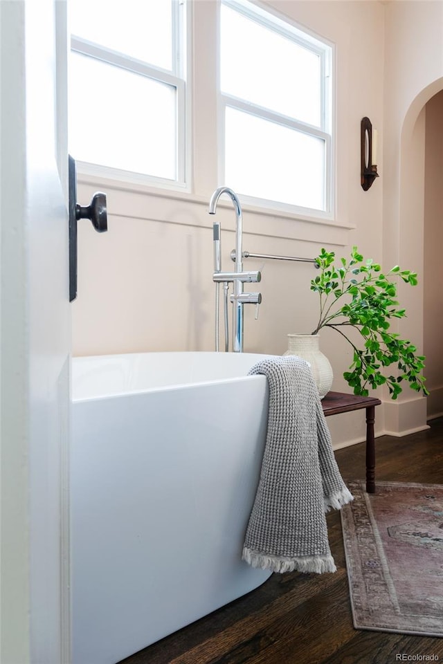 bathroom featuring a bath and hardwood / wood-style floors