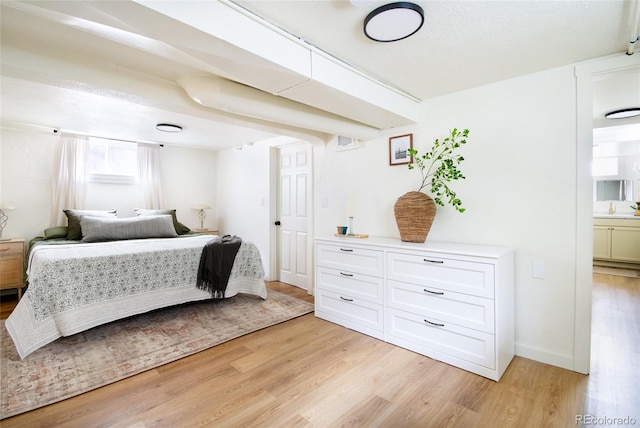 bedroom with sink and light hardwood / wood-style floors